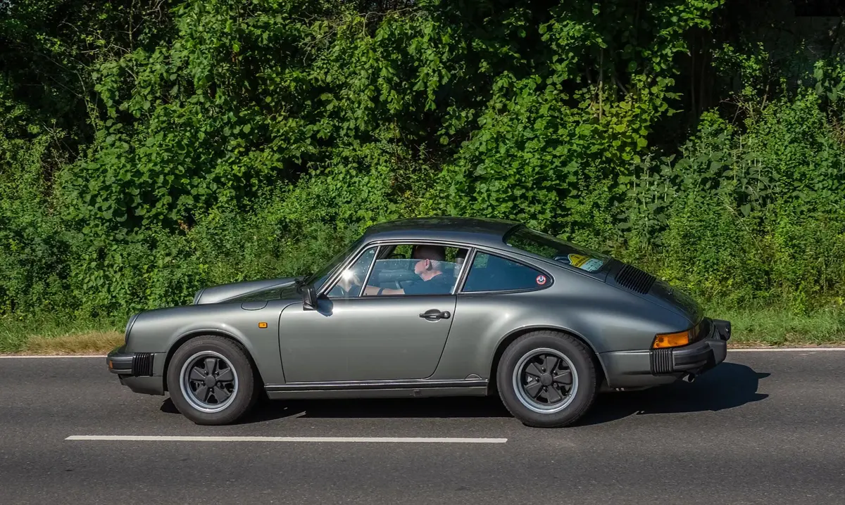 A Porsche 911 Carrera 3.2 coupe at a classic car rally